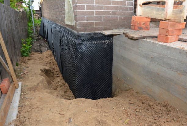 Happy homeowners after waterproofing job in Ellicott City